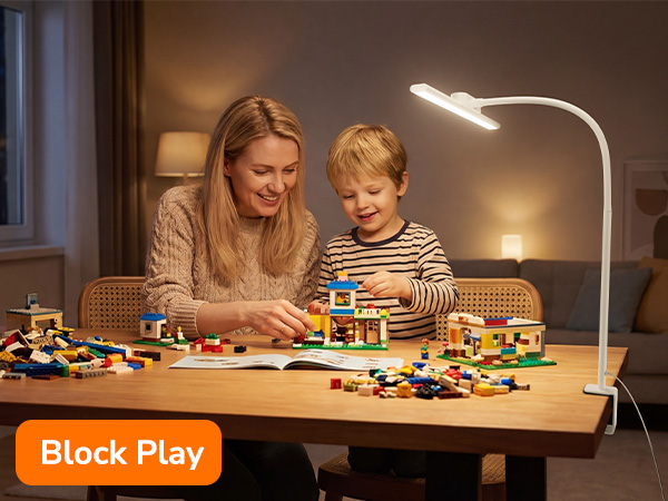 Text reads 'Block Play'. Warm-lit scene showing table with building blocks spread out, featuring LED desk lamp illuminating the play area.