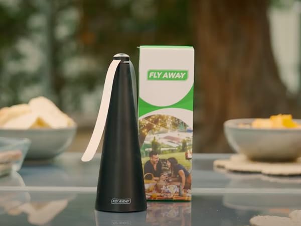 Fly Away fly fan on outdoor dining table providing quiet chemical-free fly protection during meals.