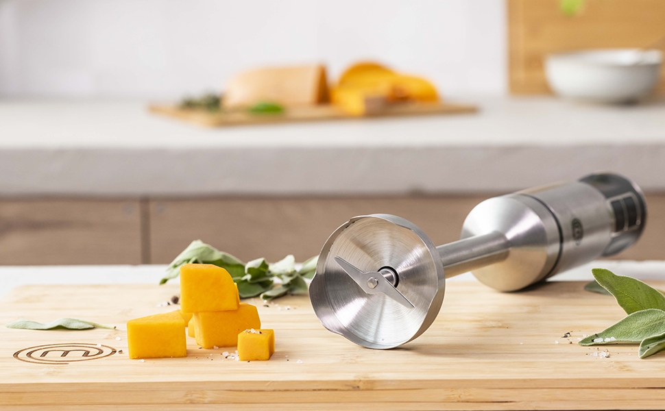 Immersion Blender with Cheese atop a MasterChef chopping board