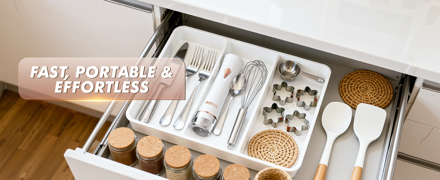 Handheld vacuum sealer stored in drawer with utensils, showing compact and easy-to-store design.