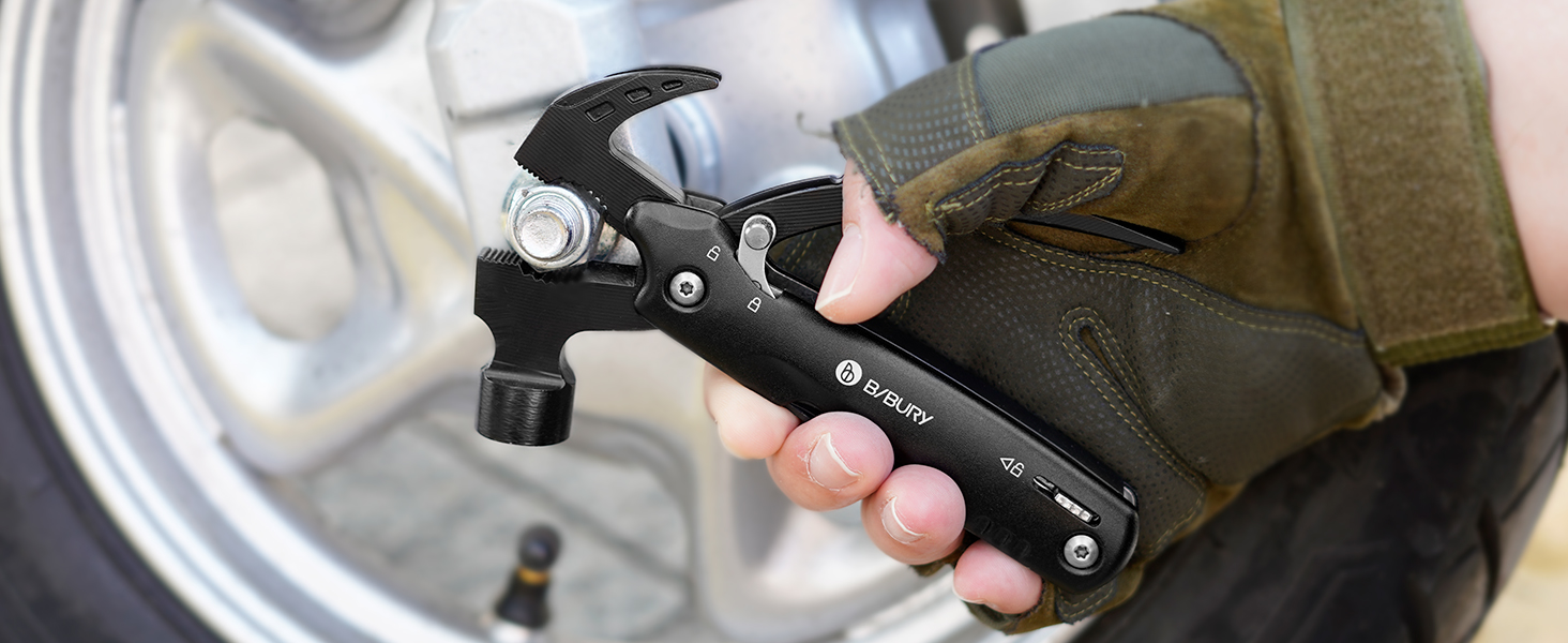 Close-up of a hand holding a black multi-tool with pliers extended, demonstrating its use on a metallic surface.