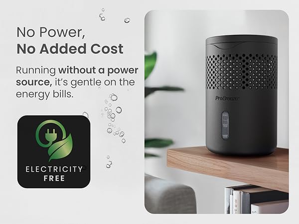 Compact black cylindrical device on wooden surface. Text indicates it runs without power, promoting energy efficiency. 'Electricity Free' icon shown.