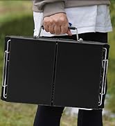Hand holding a black, rectangular briefcase with metal corner protectors and a chrome handle. The case appears compact and has a textured surface.