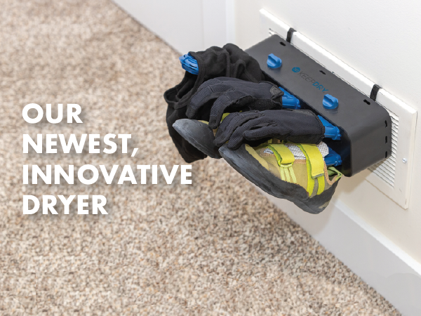 The glove dryer hands on a wall vent with cycling gloves and climbing shoes