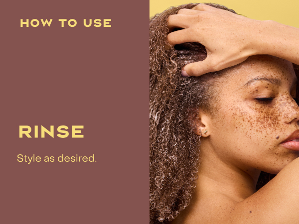 Image of a woman with curly hair rinsing it.