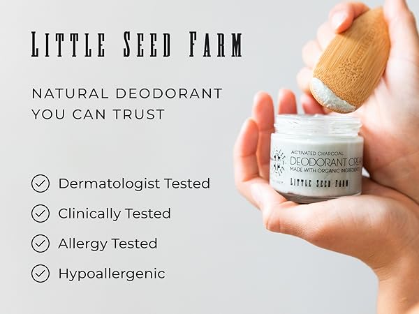 Hands holding a jar of Little Seed Farm Activated Charcoal Deodorant Cream