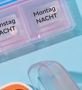 Plastic medication organizer with German text 'Montag NACHT' visible on compartments against light blue background.