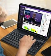 a person using a laptop computer with a video playing on the screen.