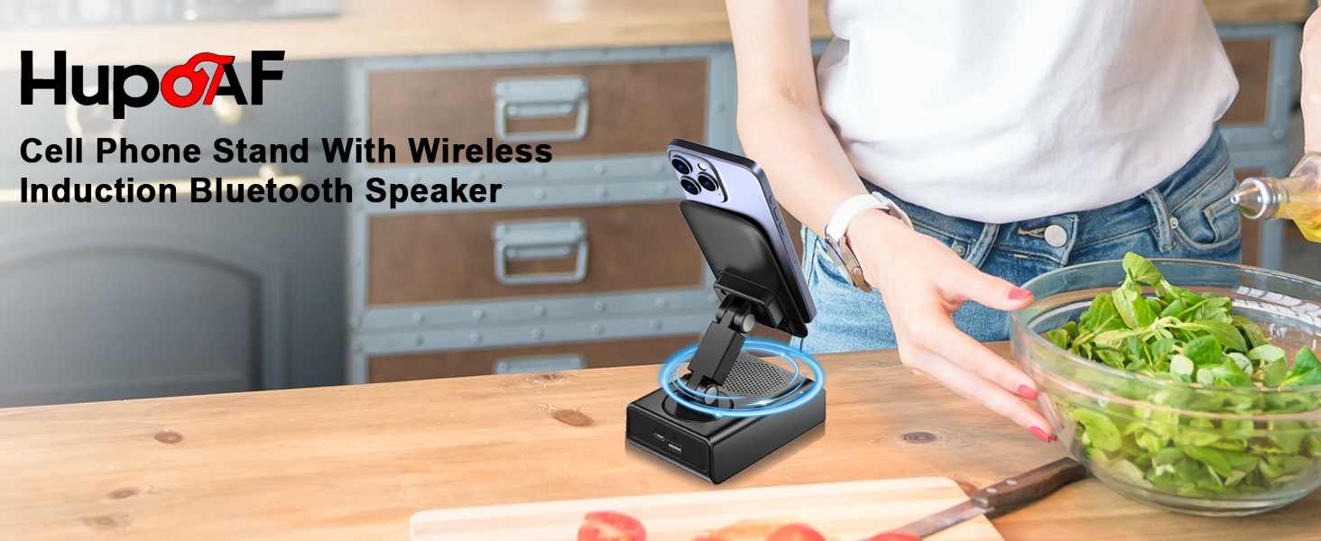 Text reads 'HupoAF' and 'Cell Phone Stand With Wireless Induction Bluetooth Speaker'. Kitchen counter scene showing device in use near food preparation area.