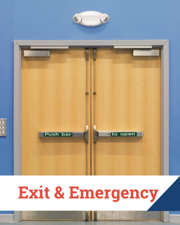 Emergency light above double push-bar exit doors in a commercial or institutional setting.