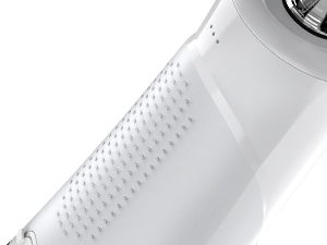 Close-up of a white cylindrical object with a textured grip pattern. Only a portion of the item is visible.