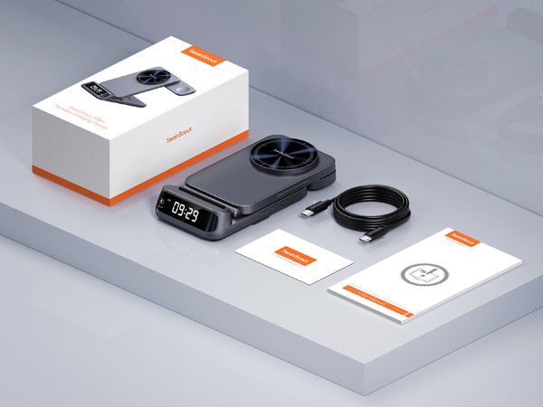 Product packaging for a digital device with circular display, showing the device, cable, and instruction manual arranged on a surface.