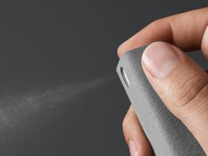 a hand holding a lighter with a spray gun on it.