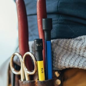 Color coded nut setters seen stored in man's tool belt. 