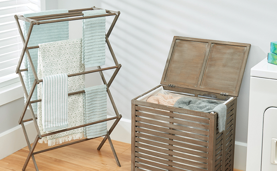 wood hamper storage box and expandable drying rack holding laundry in a laundry room setting