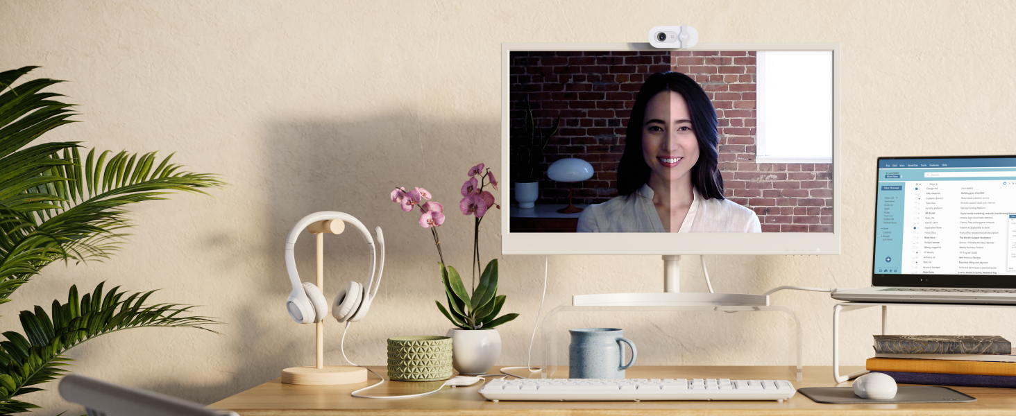 a woman having a video call using brio 100 full hd webcam for meetings and streaming