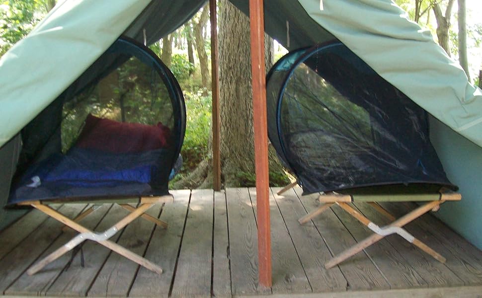 mosquito tent on a camping cot in a canvas shelter