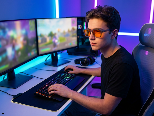 blue light blocking glasses during intense screen gaming session, eyes relaxed and comfortable