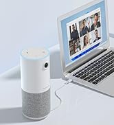 Cylindrical white smart speaker next to laptop displaying video conference. Speaker has light ring on top and fabric-covered lower half.