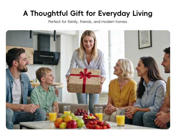 Woman presenting a wrapped gift to family and friends gathered with fresh juice