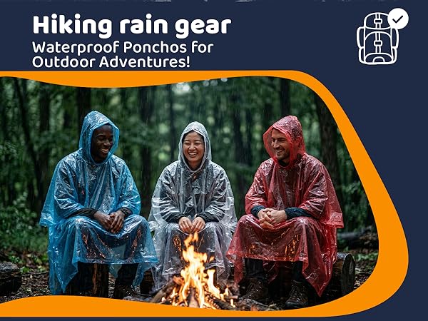 Friends in ponchos by a campfire in the rain