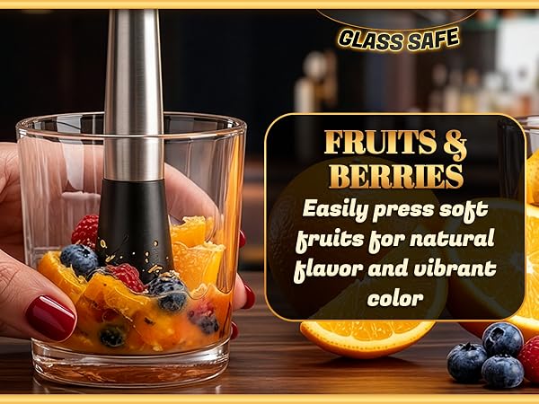 stainless steel muddler crushing citrus in glass showing use with fruits and berries