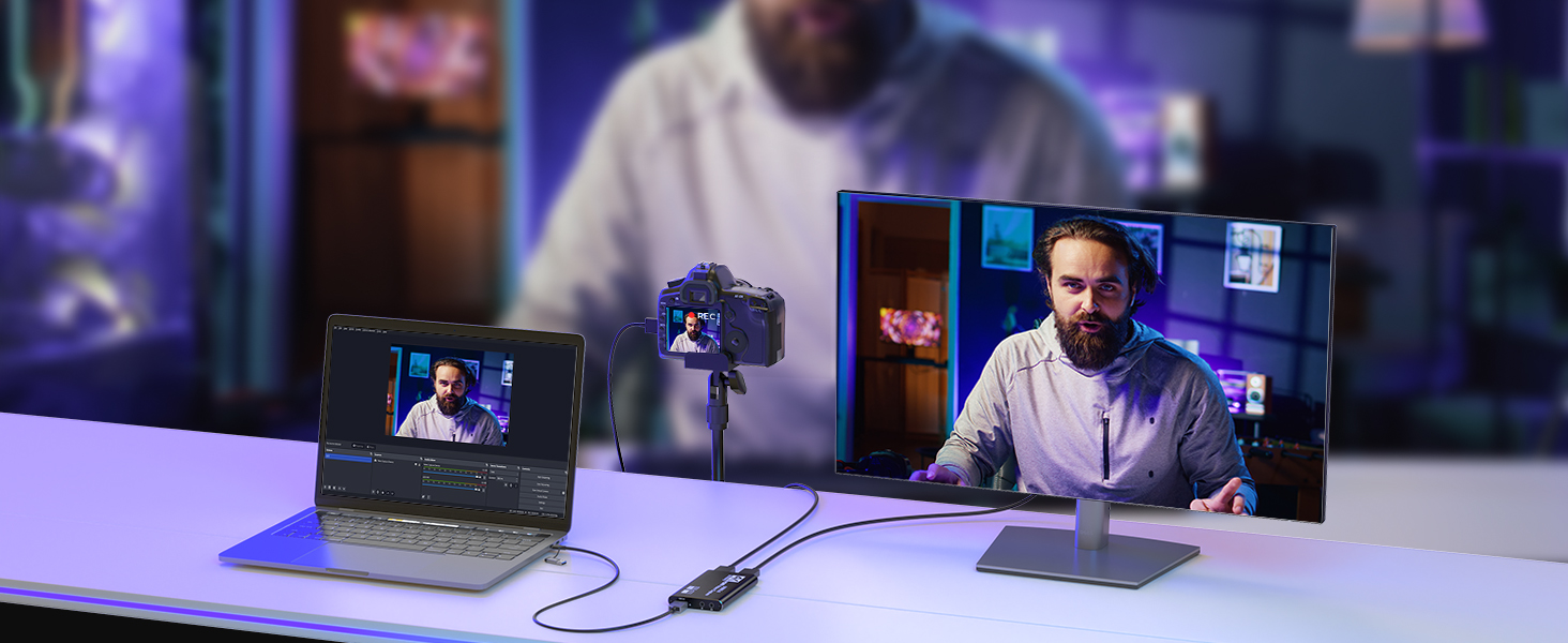 a laptop and a camera are on a table.