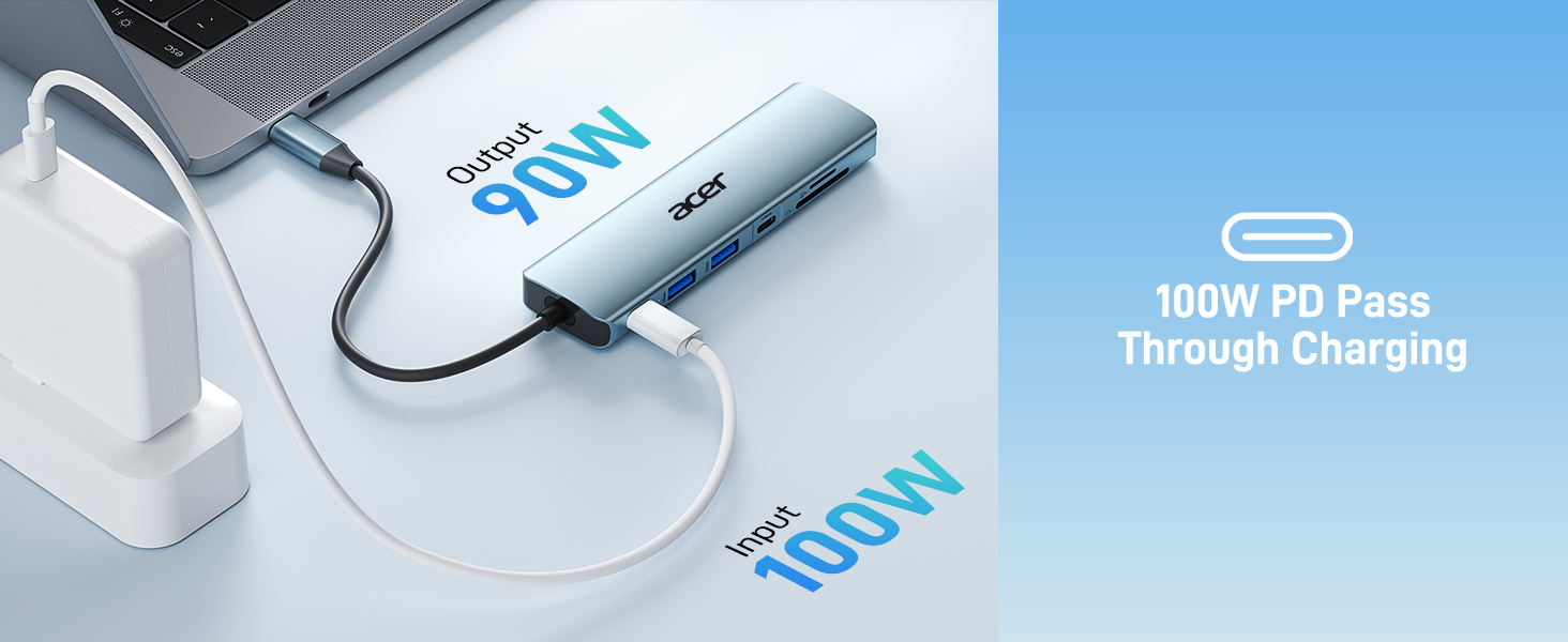 Sleek silver portable charger with '100W PD Pass Through Charging' text and connected charging cables on blue-tinted surface.