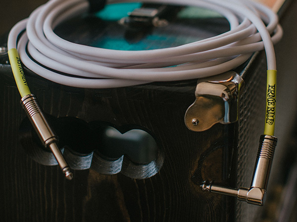 white guitar cable on amp