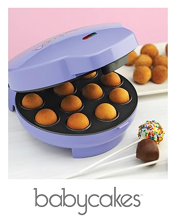 Babycakes cake pop maker with 12 baked cake pops inside and decorated cake pops on a plate