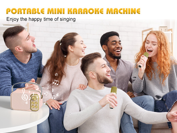 Portable mini karaoke machine in pink. Group of people on a couch singing and enjoying karaoke together, demonstrating the product's use.