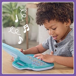 Kid pushes button and toy laptop makes exciting noises.