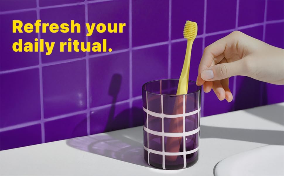 Person using Tonochi soft bristle toothbrush during daily oral care routine.