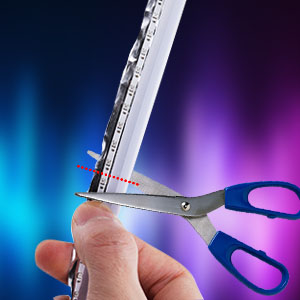 Hand holding silver scissors cutting a measuring tape against a colorful blue and purple background. The scissors have a ruler printed along one blade.