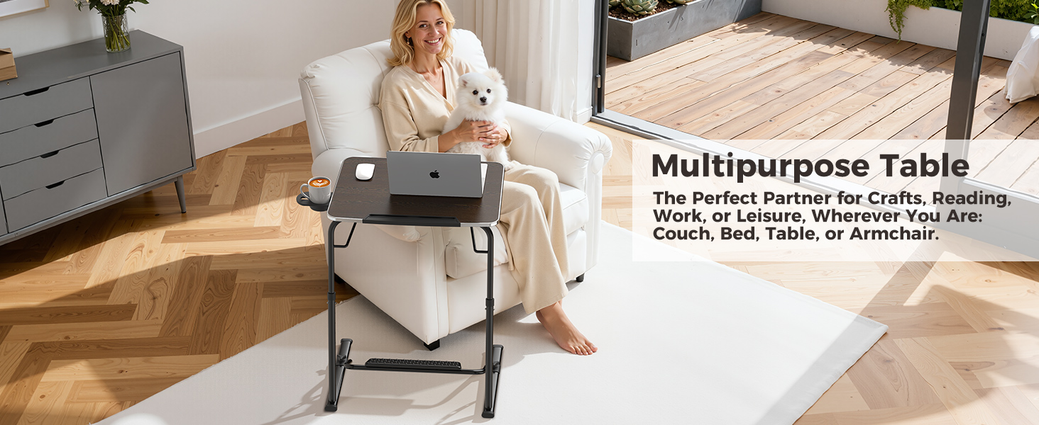 Woman using foldable laptop table as an armchair table while relaxing with her dog.