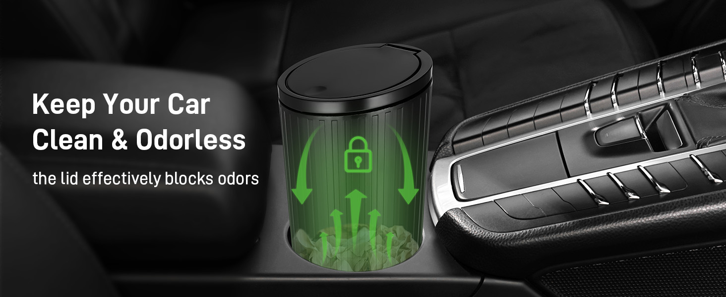 Car air freshener device with black lid and green glowing effect, shown in vehicle console. Text indicates it blocks odors.