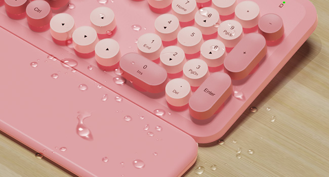 Water droplets on wireless keyboard and wrist rest showing splash resistant design easy wipe clean