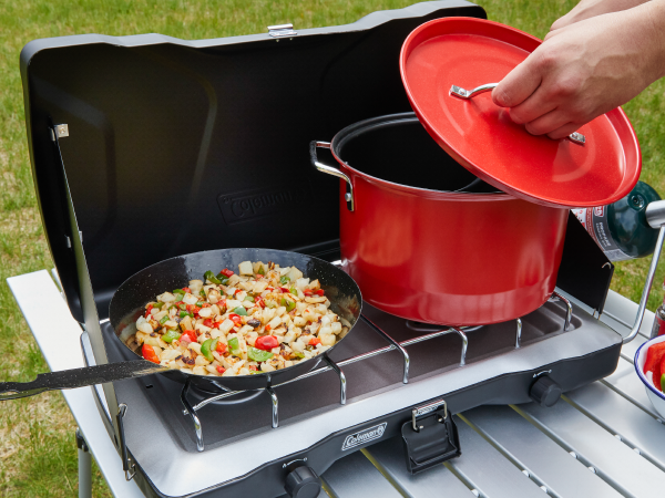 coleman stove grill breakfast pan pot red propane table seasoning bowl grass yard tailgate bbq camp