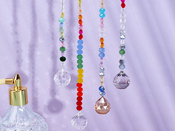 Colorful crystal suncatchers with various bead shapes and sizes. Hanging strings feature rainbow colors and clear crystals.