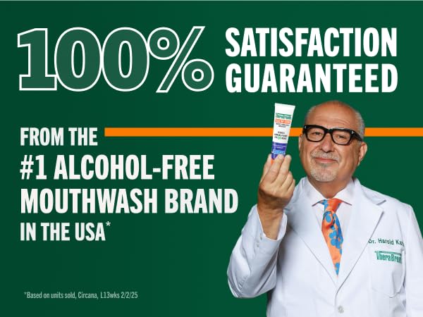 Dentist and therabreath founder smiles confidently in a white lab while holding a tube of toothpaste