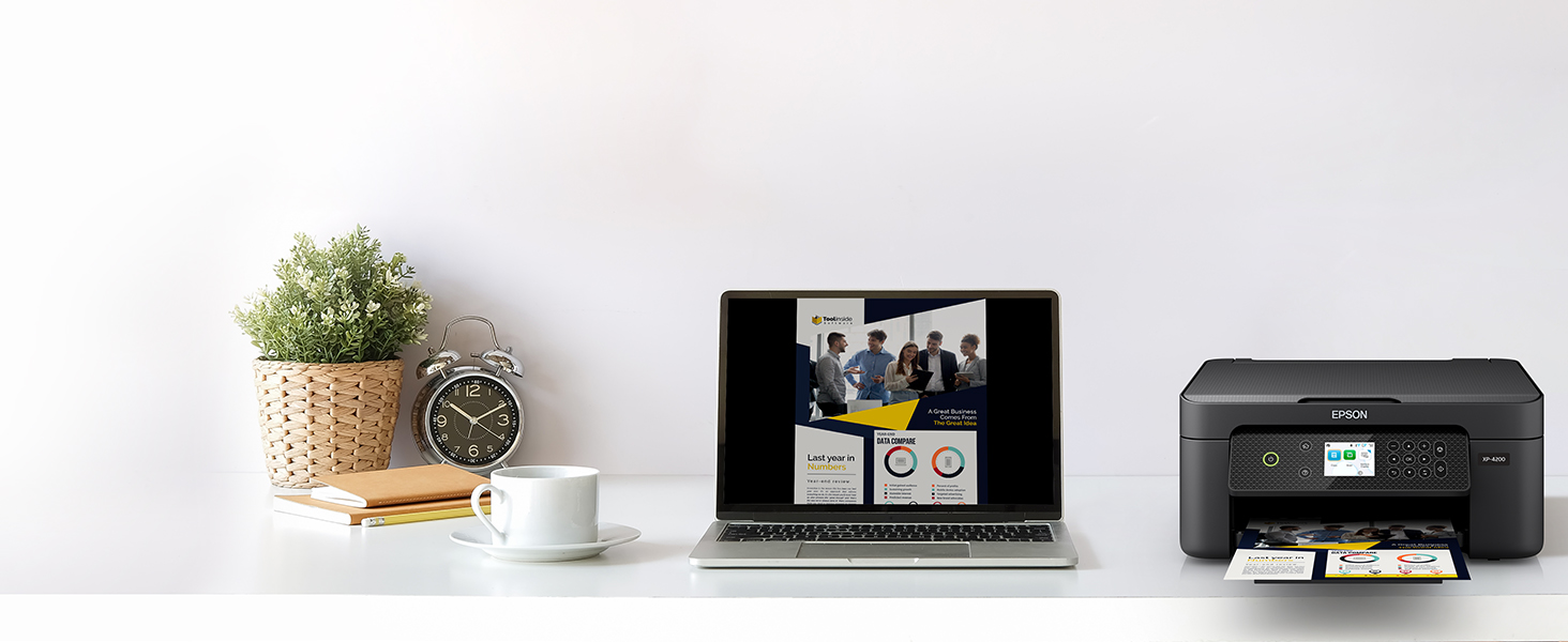 Black Expression Home XP-4200 on desk wirelessly printing content from laptop.