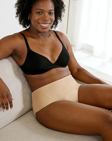 Lifestyle product photography showing comfortable loungewear in neutral beige tones against white furniture and background.