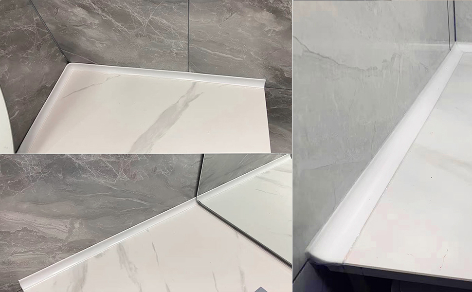 Close-up of white and gray marble-patterned surfaces meeting at a corner, showing tile or panel installation detail.
