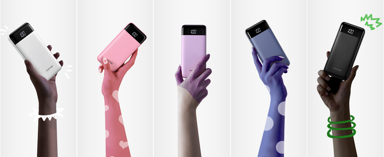 Five hands holding smartphones in different colors: white, pink, purple, navy, and black. Hands wear contrasting accessories like bracelets.