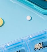 Partial view of light blue plastic surface with small white dots or elements visible.