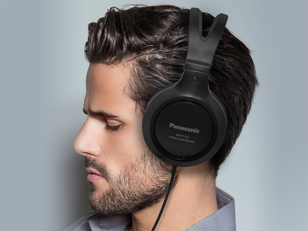 caucasian brunette man wearing the Panasonic RP-HT161 over-ear headphones with eyes closed