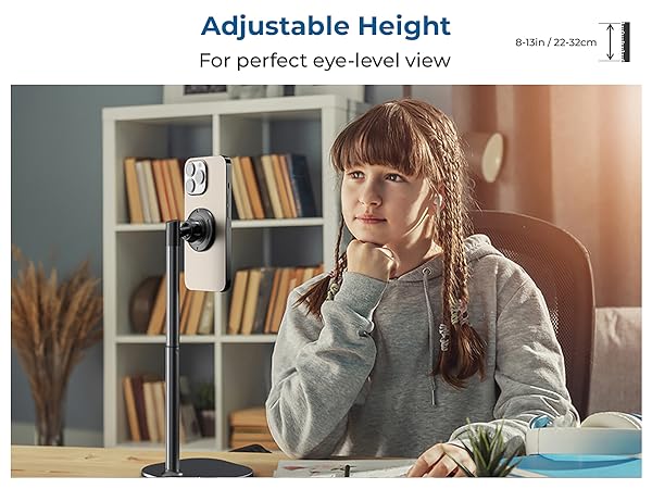 Adjustable webcam or camera mount with height adjustment feature ranging from 29-52cm, shown in home office setting.