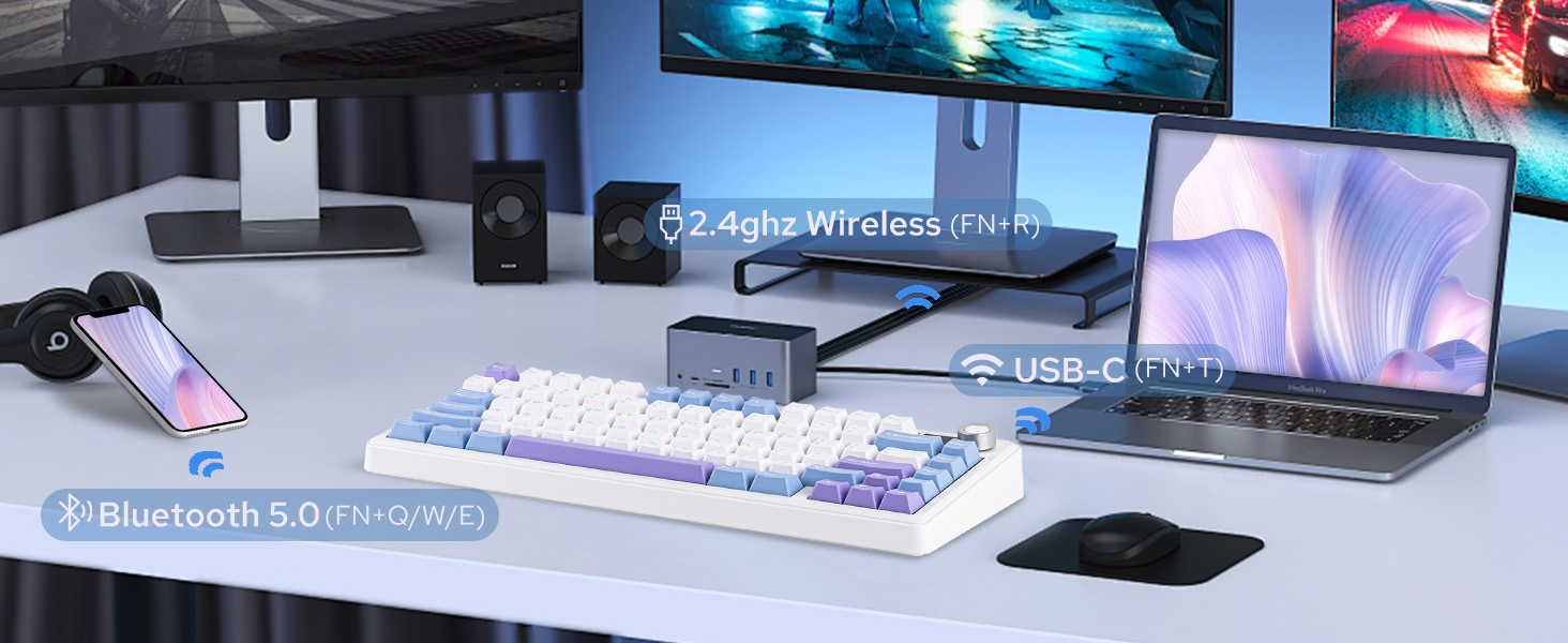 a white desk with a keyboard, mouse, speakers and a mouse.