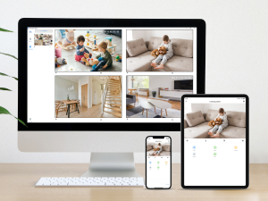 Digital devices displaying interior design images. Desktop monitor shows grid of room photos, tablet and smartphone show single images.