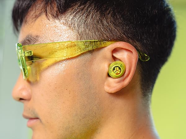 close up of yellow clear earbuds